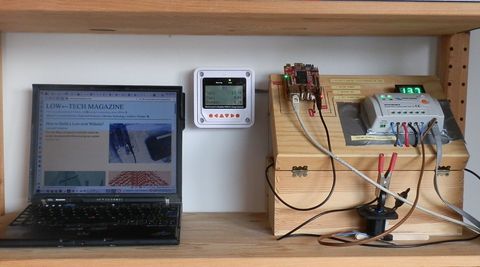 A laptop displaying a solar-powered blog with some machinery sitting next to it.