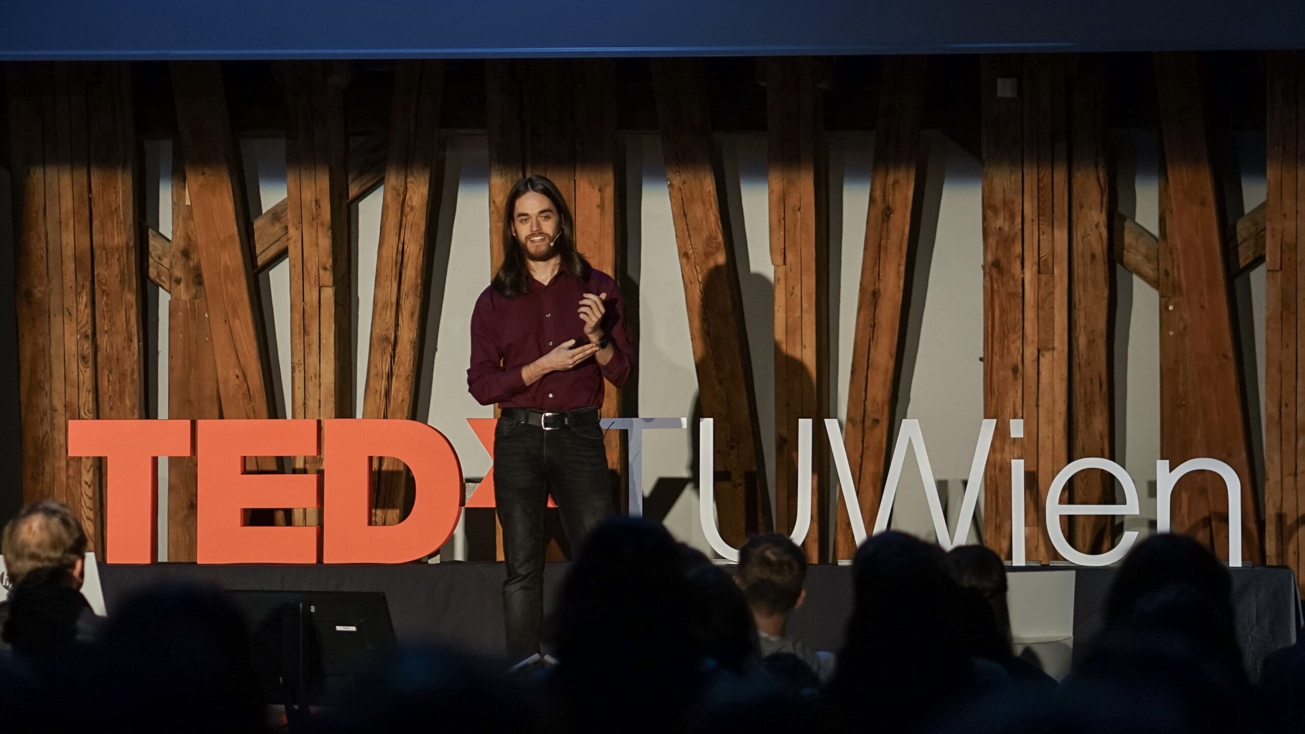 Michael Koppmann on stage at TEDxTUWien giving his talk on the era of green software.
